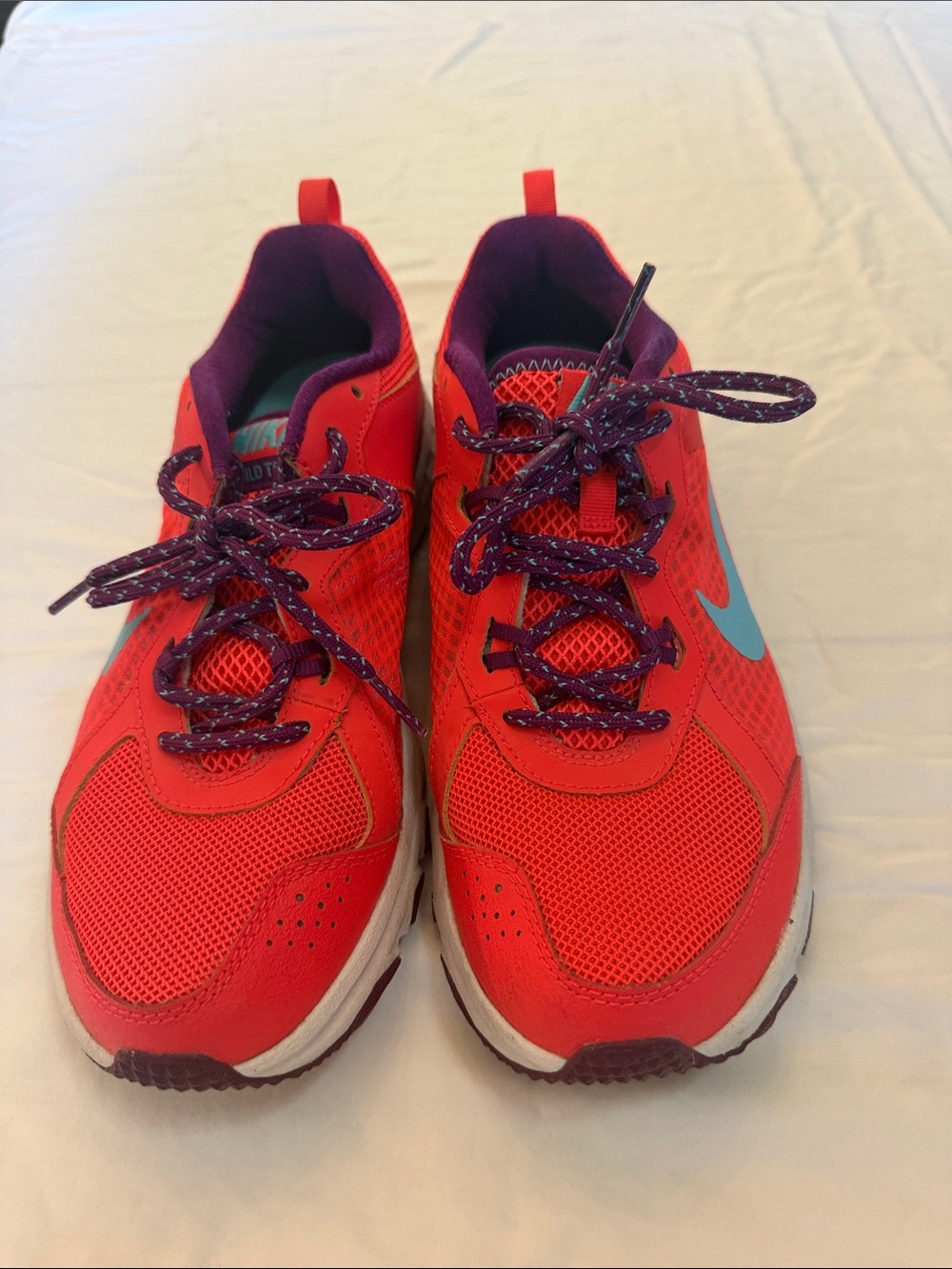 Nike women’s Neon Red Sneakers with Teal Swoosh and Purple Accents